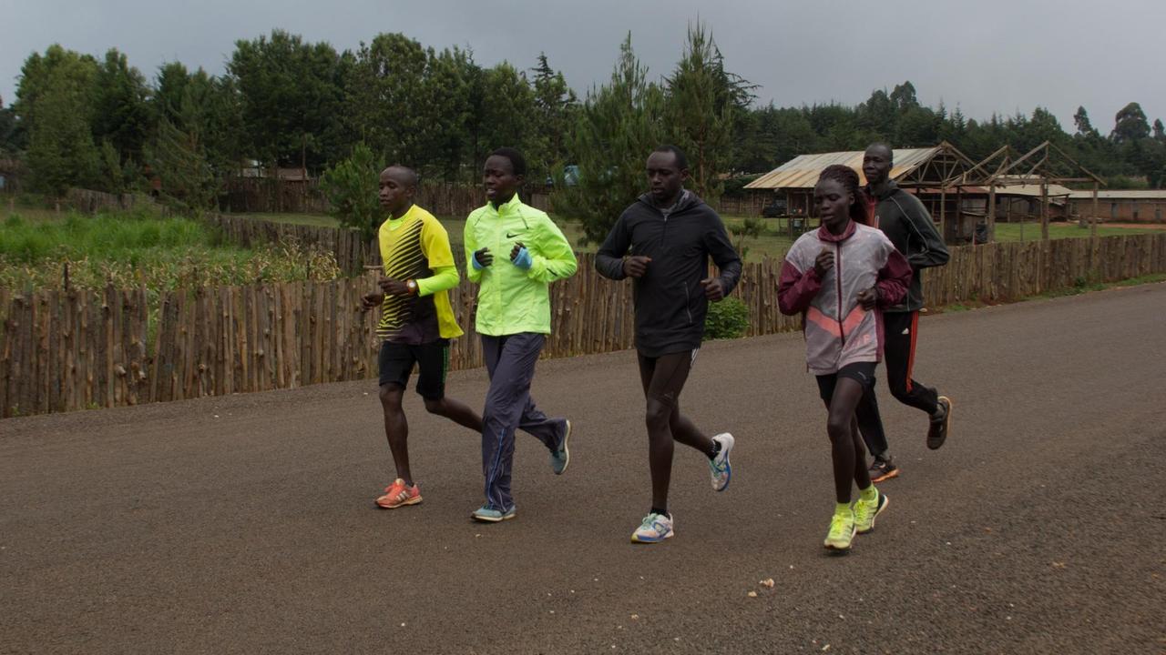 Susy Chebet Chemaimak mit ihrer Laufgruppe auf der Straße. Susy Chebet Chemaimak mit ihrer Laufgruppe auf der Straße.