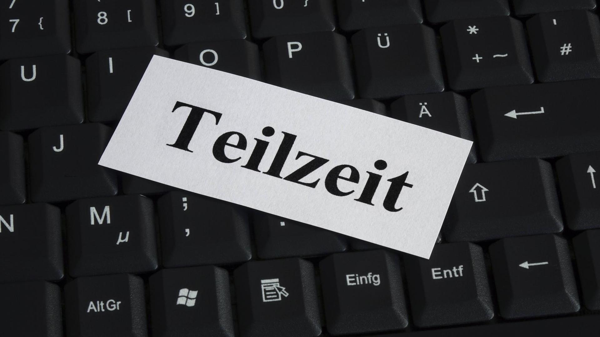 Eine Computertastatur, darüber liegt ein Schild mit der Aufschrift "Teilzeit" Eine Computertastatur, darüber liegt ein Schild mit der Aufschrift "Teilzeit"