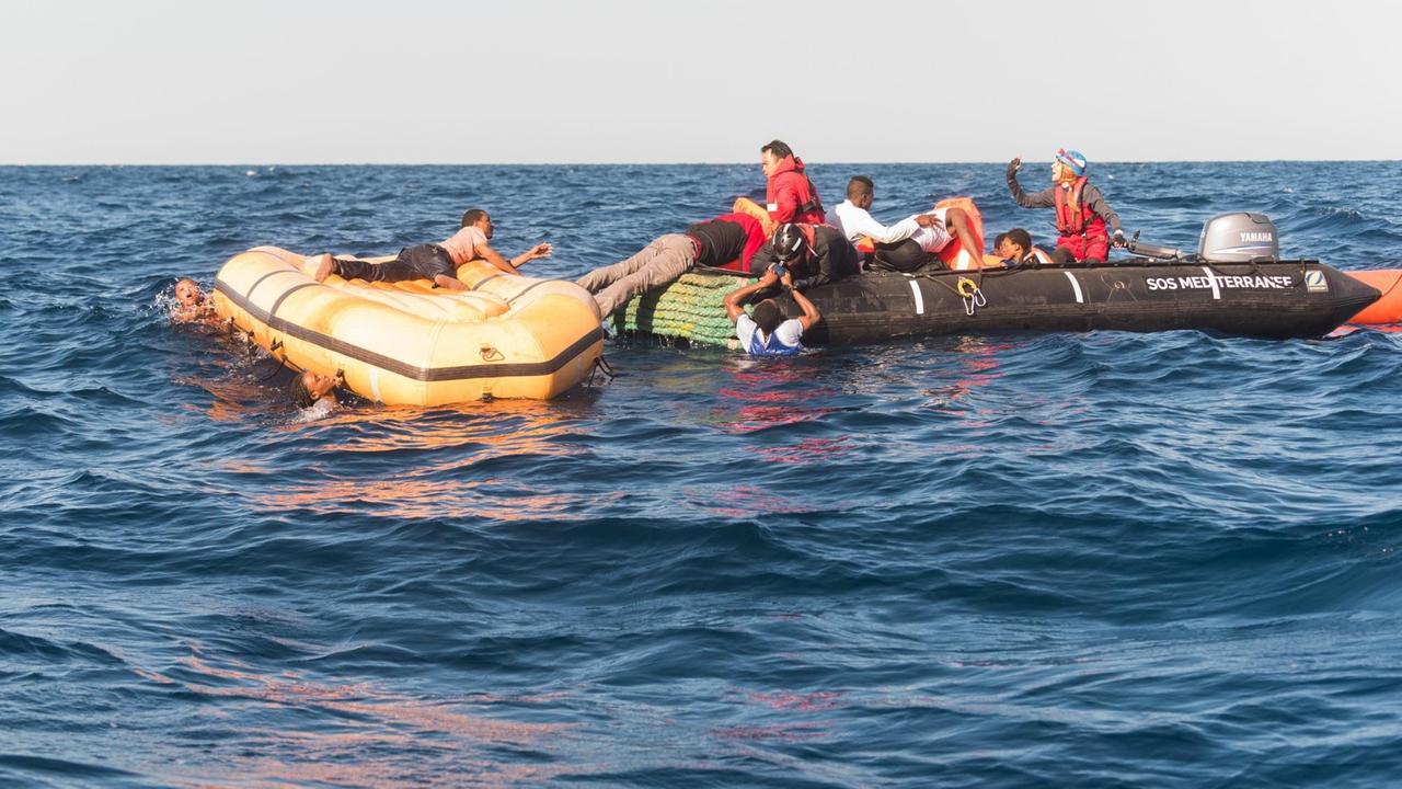 Such- und Rettungsmission im Mittelmeer vor der libyschen Küste. Zu sehen sind zwei Schlauchboote mit Menschen an Bord. Such- und Rettungsmission im Mittelmeer vor der libyschen Küste. Zu sehen sind zwei Schlauchboote mit Menschen an Bord.