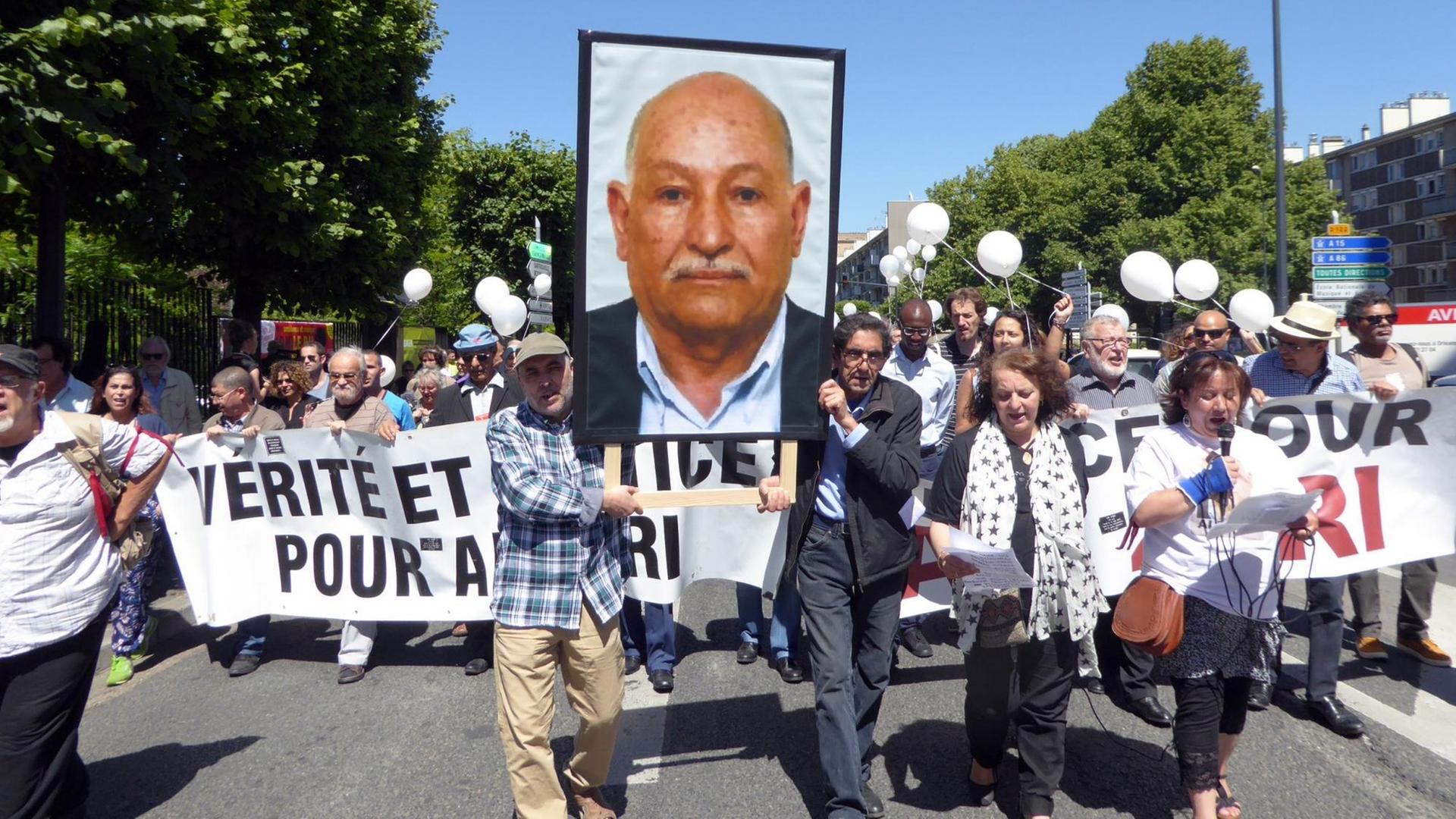 In der Pariser Vorstadt Argenteuil fordern mehr als hundert Menschen auf einem Plakat "Justiz und Gerechtigkeit für Ali Ziri", der der Polizeigewalt in Frankreich zum Opfer fiel. Sie halten ein Bild von ihm in die Höhe. In der Pariser Vorstadt Argenteuil fordern mehr als hundert Menschen auf einem Plakat "Justiz und Gerechtigkeit für Ali Ziri", der der Polizeigewalt in Frankreich zum Opfer fiel. Sie halten ein Bild von ihm in die Höhe.