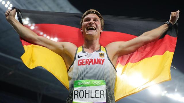 Der deutsche Speerwerfer Thomas Roehler holt Gold bei den Olympischen Spielen in Rio. Hier feiert er seinen Erfolg im Stadion, die deutsche Fahne um die Schultern.