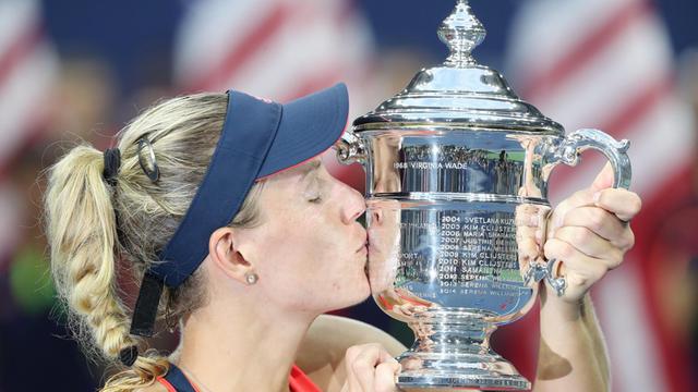 Die Kielerin Angelique Kerber küsst den Pokal, den sie nach ihrem US-Open-Sieg gegen die Tschechin Karolina Pliskowa in den Händen hält.