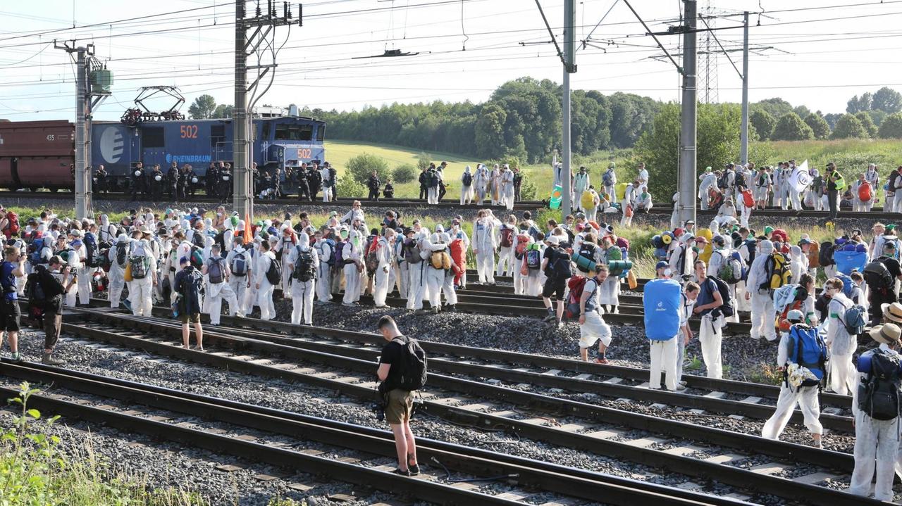 Aktivisten stehen auf den Gleisen der Kohle-Transportbahn und blockieren diese. Aktivisten stehen auf den Gleisen der Kohle-Transportbahn und blockieren diese.
