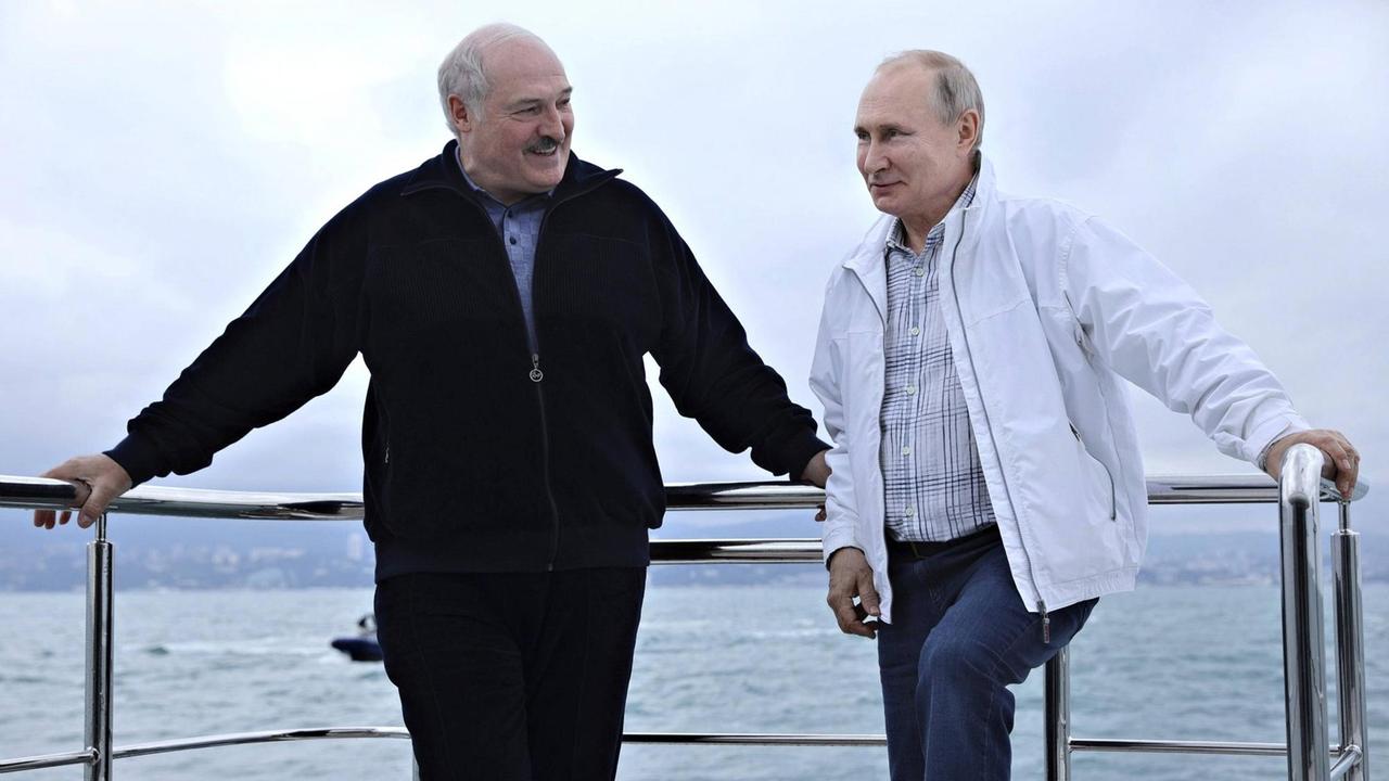 Russian President Vladimir Putin chats with Belarus President Alexander Lukashenko, left, during a yacht trip on the Black Sea May 29, 2021 in Sochi, Russia.