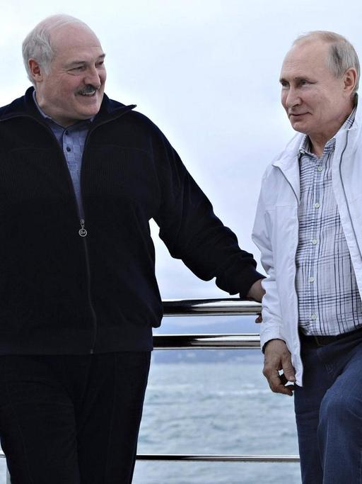Russian President Vladimir Putin chats with Belarus President Alexander Lukashenko, left, during a yacht trip on the Black Sea May 29, 2021 in Sochi, Russia.