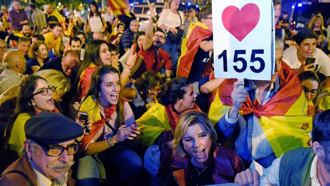 Demonstranten mit spanischen Flaggen fordern die Anwendung des Artikels 155 der spanischen Verfassung, wonach die Zentralregierung die katalanische Regionalregierung de facto entmachten kann Demonstranten mit spanischen Flaggen fordern die Anwendung des Artikels 155 der spanischen Verfassung, wonach die Zentralregierung die katalanische Regionalregierung de facto entmachten kann