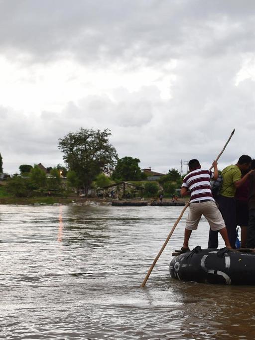 Migranten benutzen ein behelfsmäßiges Floss, um den Suchiate-Fluss, der die natürliche Grenze zwischen Mexiko und Guatemala markiert, zu überqueren (Archivbild 2014)
