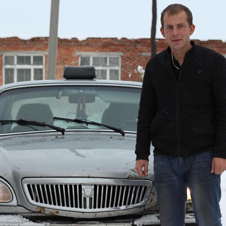 Der 31-jährige Taxifahrer Sergej vor seinem Wolga