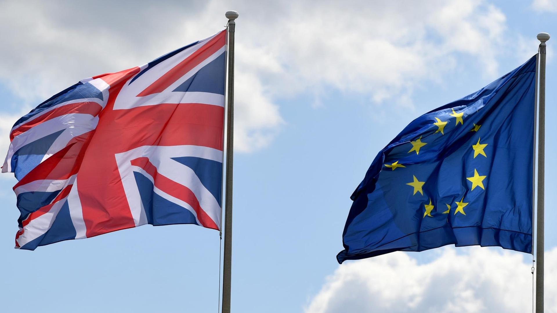 Die Flaggen Großbritannien und der Europäischen Union wehen im Wind. Die Flaggen Großbritannien und der Europäischen Union wehen im Wind.