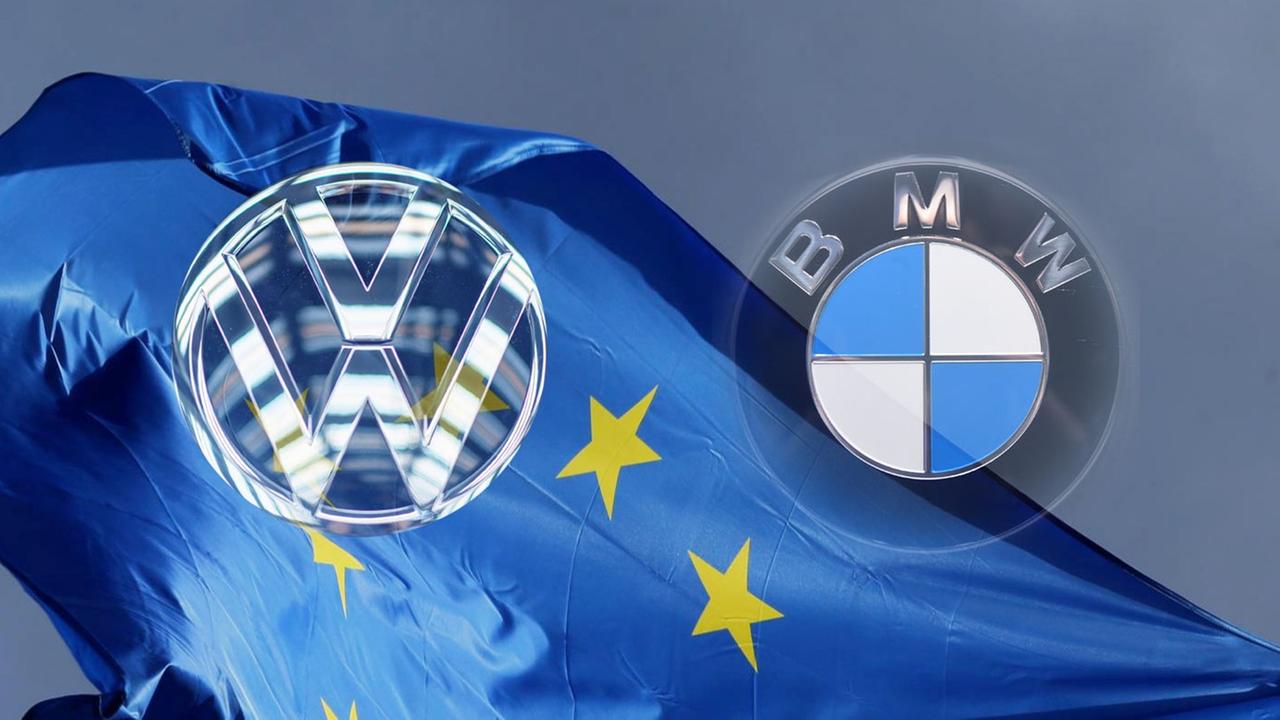 Die Logos von VW und BMW vor einer Flagge von der EU.