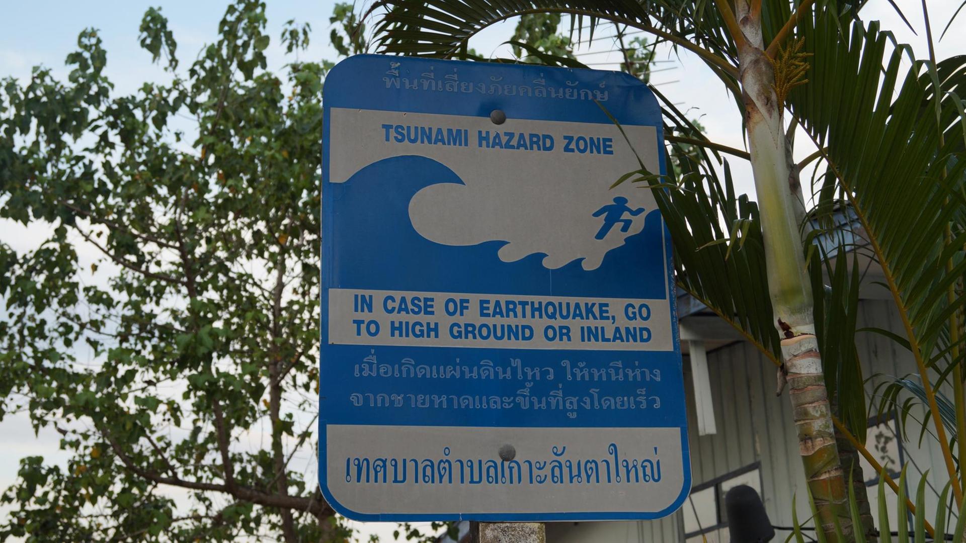 Ein thailändisches Hinweisschild zur Evakuierung bei einem Tsunami. Ein thailändisches Hinweisschild zur Evakuierung bei einem Tsunami.