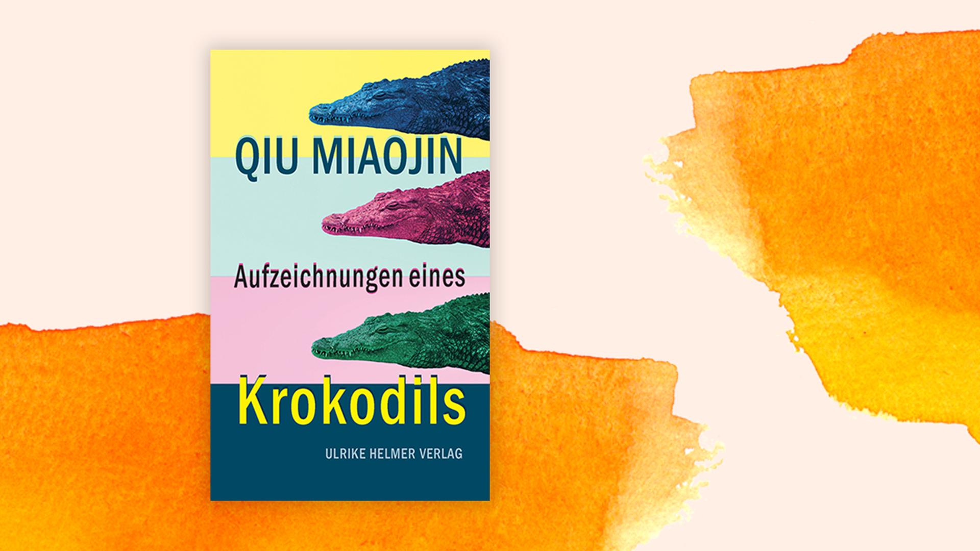 Buchcover von Qiu Miaojins "Aufzeichnungen eines Krokodils", vor einem Aquarell-Hintergrund. Buchcover von Qiu Miaojins "Aufzeichnungen eines Krokodils", vor einem Aquarell-Hintergrund.