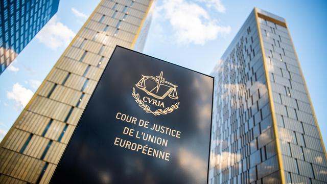 Das Bild zeigt ein Schild vor den Bürotürmen des Europäischen Gerichtshofs mit der Aufschrift "Cour de Justice de l'union Européene" im Europaviertel auf dem Kirchberg.