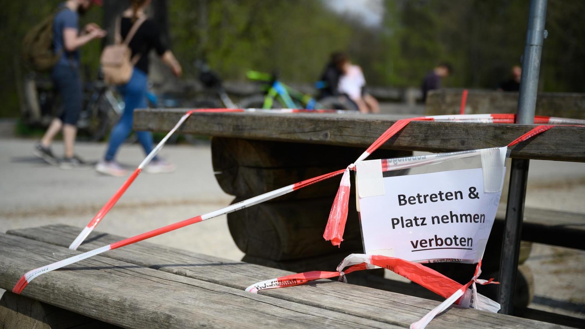 Ein Schild mit der Aufschrift "Betreten & Platz nehmen verboten" hängt am 13.04.2020 am Bärenschlössle, einem beliebten Ausflugsziel in Stuttgart, an einer Bank.
