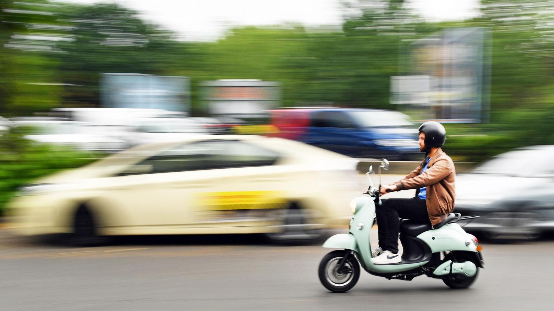 Ein junger Mann fährt auf einem unu Elektroroller vom Mobilitäts-Start-up Unu am 29.06.2017 auf einer Straße in Berlin. Der E-Roller hat eine Reichweite von 50 Kilometern mit einem tragbaren Lithium-Ionen-Akku, der auswechselbar ist und an jeder Steckdose aufgeladen werden kann Ein junger Mann fährt auf einem unu Elektroroller vom Mobilitäts-Start-up Unu am 29.06.2017 auf einer Straße in Berlin. Der E-Roller hat eine Reichweite von 50 Kilometern mit einem tragbaren Lithium-Ionen-Akku, der auswechselbar ist und an jeder Steckdose aufgeladen werden kann