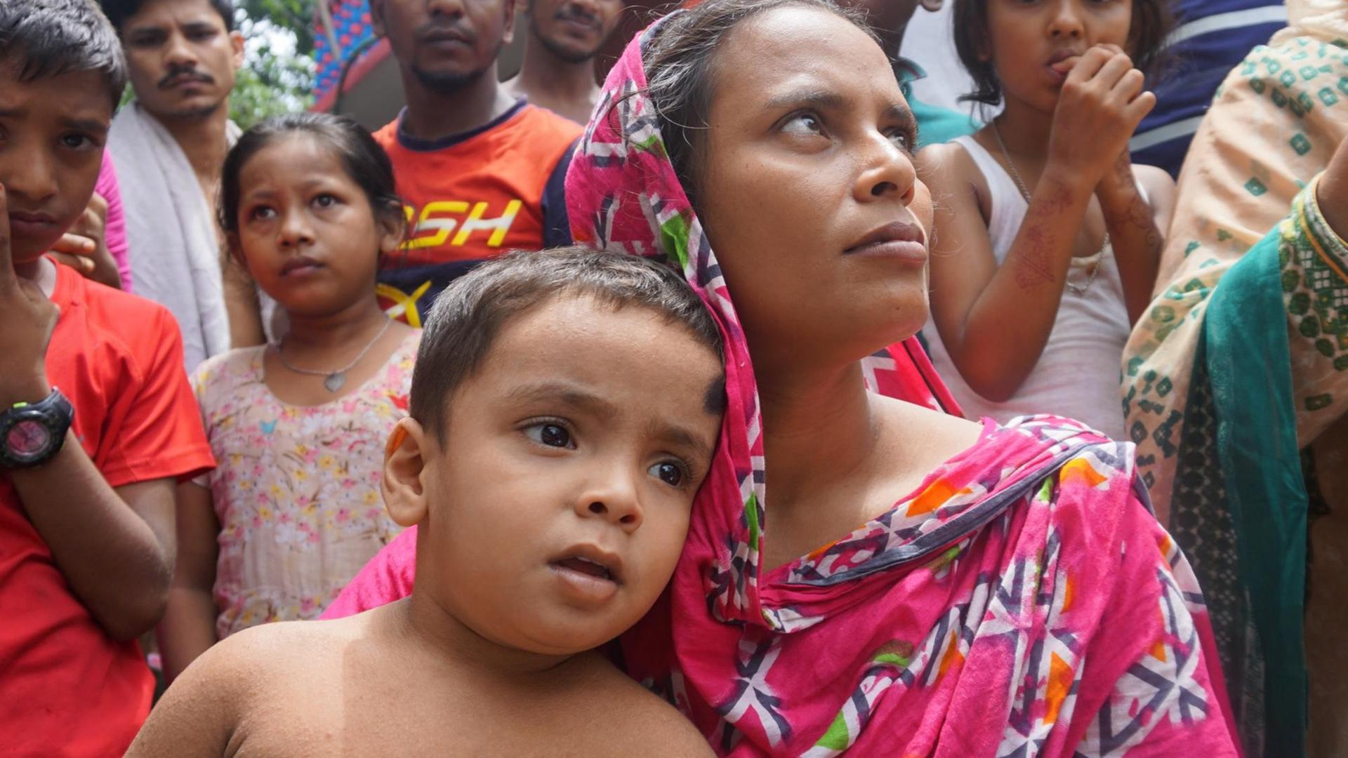 Die 30-jährige Näherin Mina mit ihrem jüngsten Sohn, aufgenommen in Bangladesch Die 30-jährige Näherin Mina mit ihrem jüngsten Sohn, aufgenommen in Bangladesch