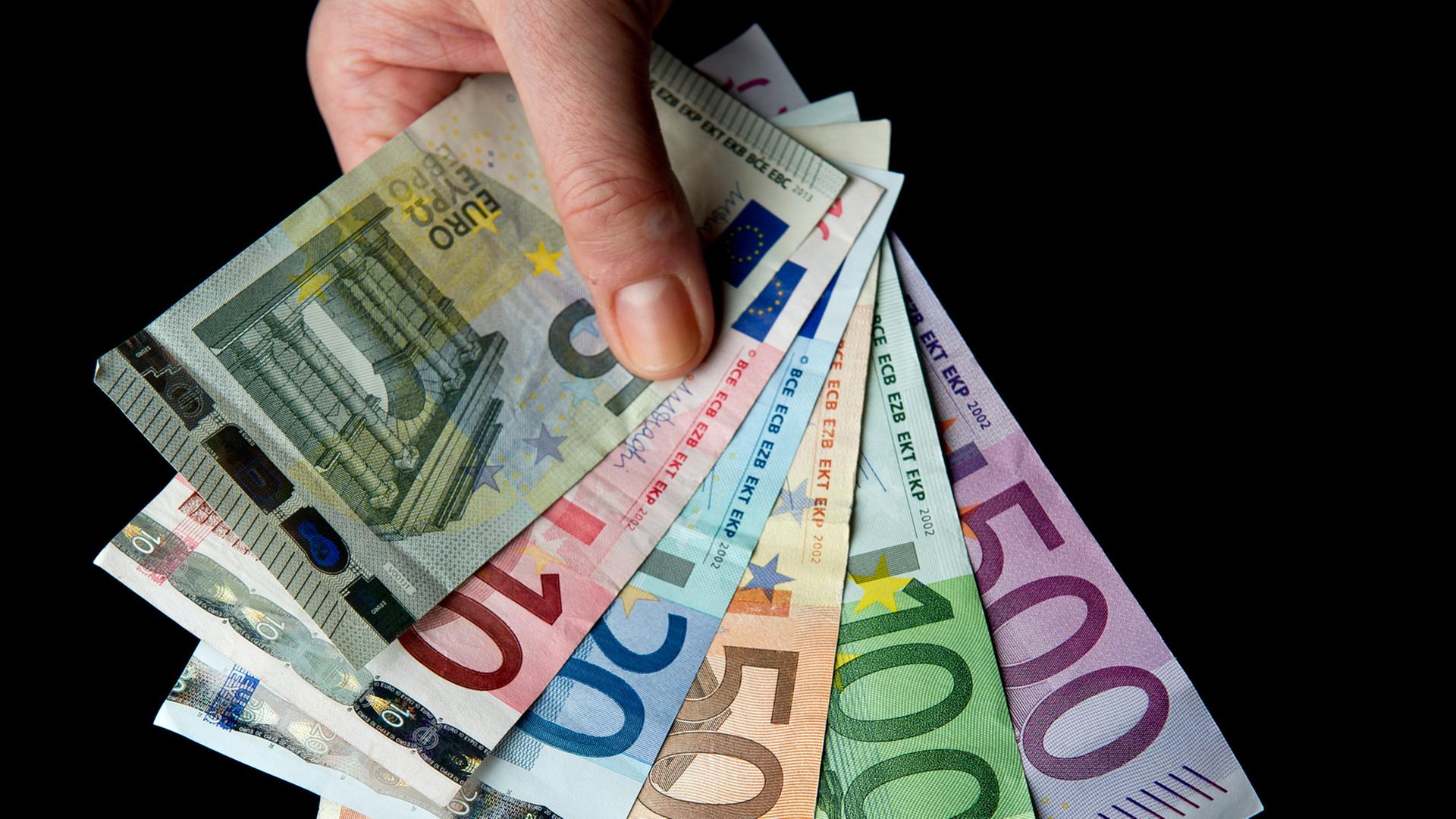 Eine Hand hält die sechs verschiedenen Banknoten zu 5, 10, 20, 50, 100 und 500 Euro. Eine Hand hält die sechs verschiedenen Banknoten zu 5, 10, 20, 50, 100 und 500 Euro.