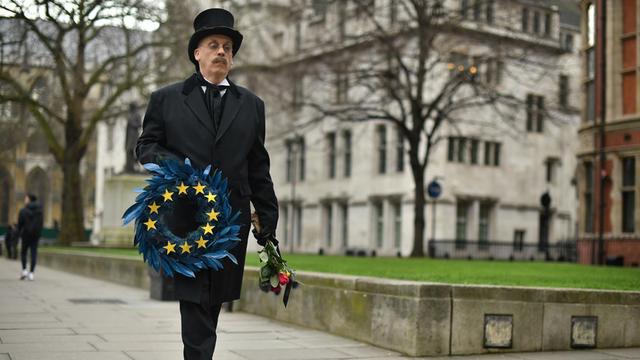 Auf dem Foto trägt ein Mann in London die EU symbolisch zu Grabe.