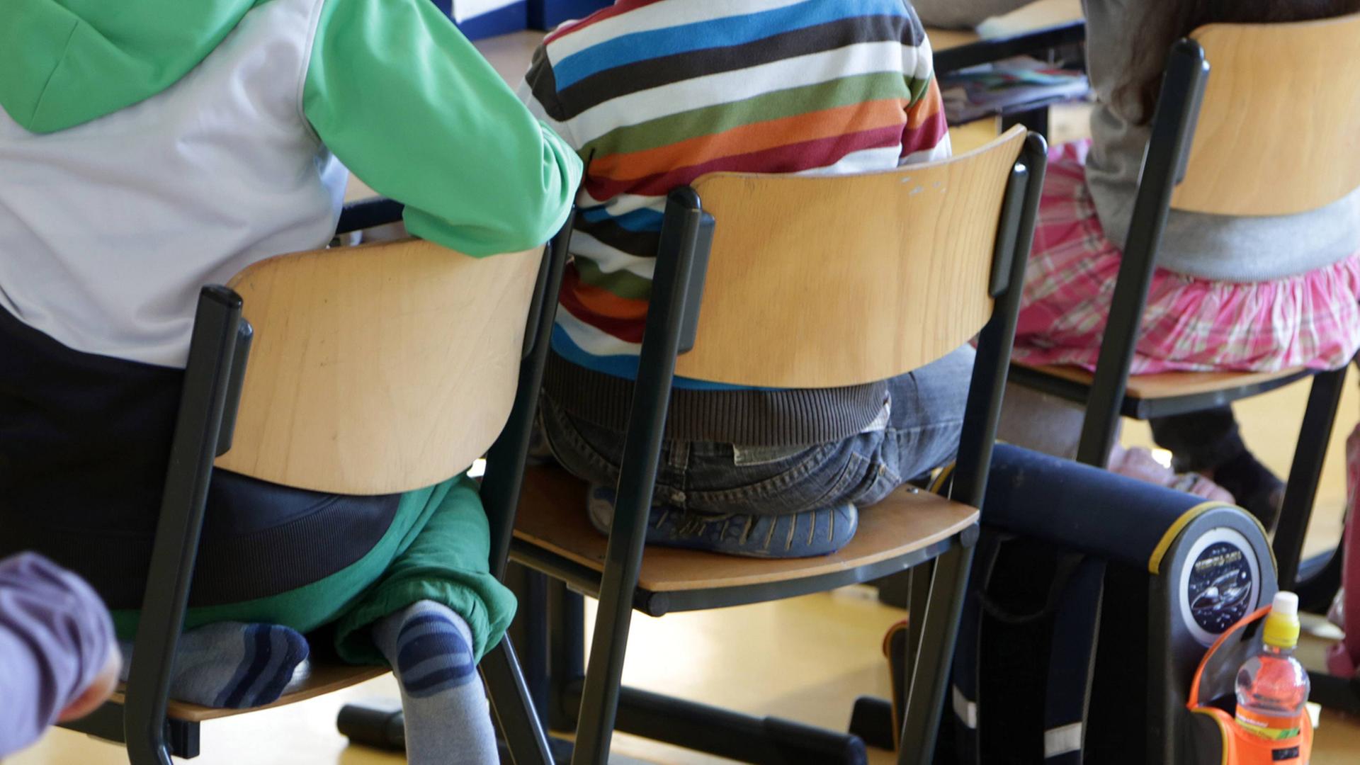 Schüler sitzen in der Klasse (Blick auf die Stühle und die Rücken der Schüler) Schüler sitzen in der Klasse (Blick auf die Stühle und die Rücken der Schüler)