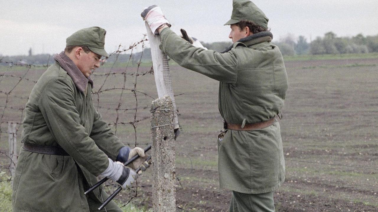 Ungarische Grenzbeamte schneiden im Mai 1989 an der Grenze zu Österreich ein Loch in den "Eisernen Vorhang" Ungarische Grenzbeamte schneiden im Mai 1989 an der Grenze zu Österreich ein Loch in den "Eisernen Vorhang"