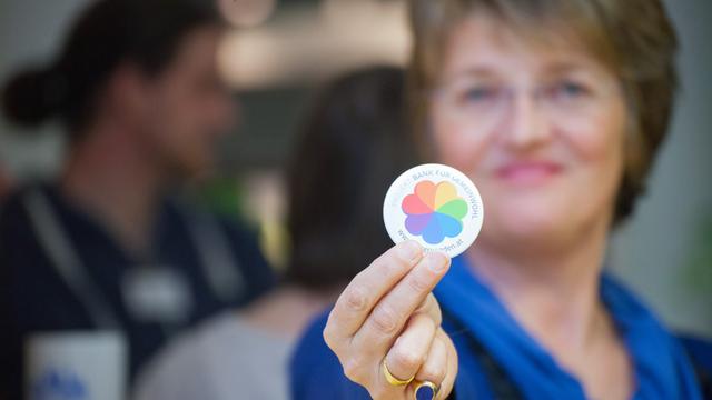 "Bank für Gemeinwohl" in Wien: Vorständin Christine Tschütscher mit einem biologisch abbaubaren Werbe-Sticker