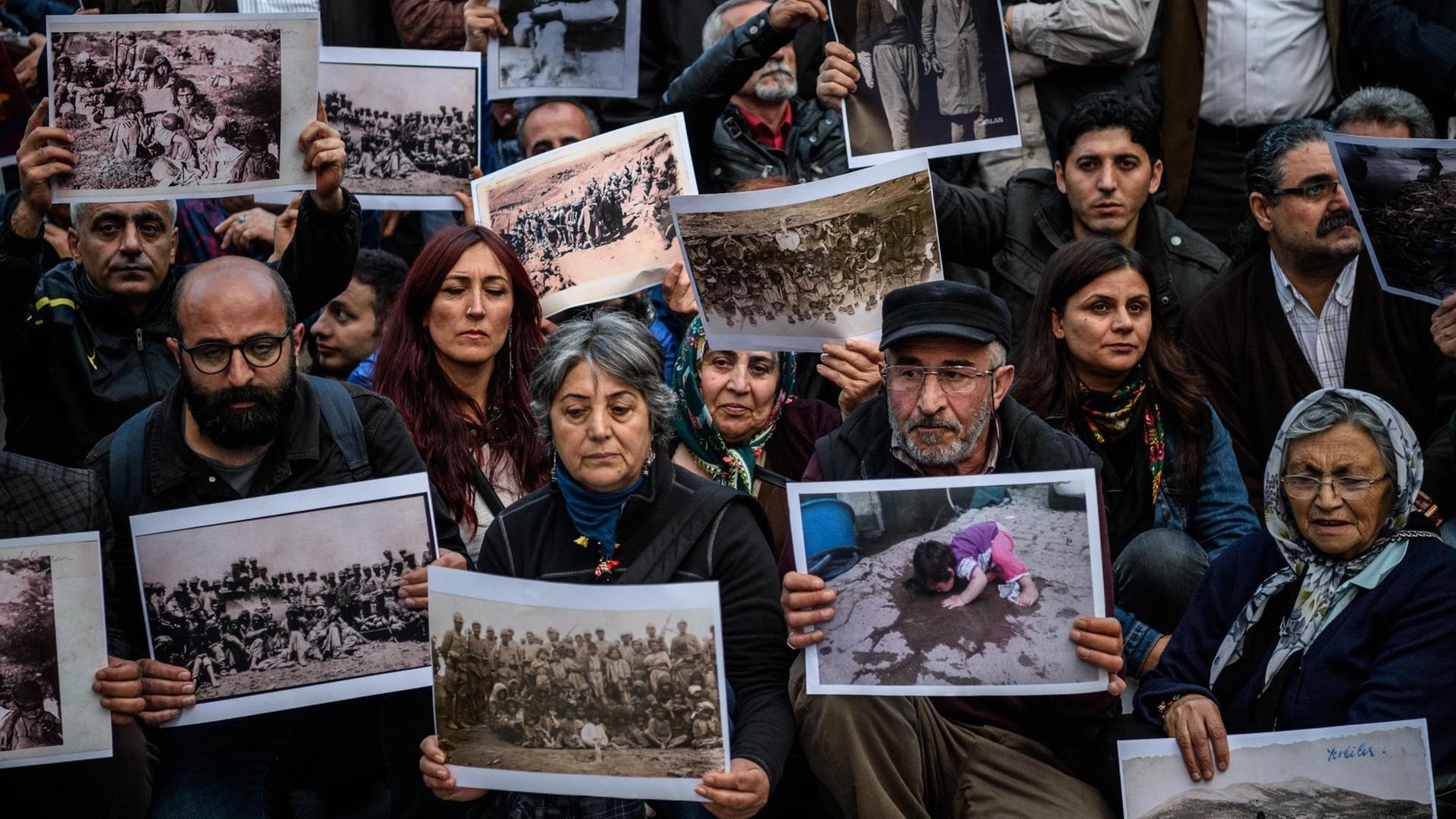 Demonstranten halten Fotos von Opfern des Massakers von Dersim 1937/38 in die Höhe Demonstranten halten Fotos von Opfern des Massakers von Dersim 1937/38 in die Höhe