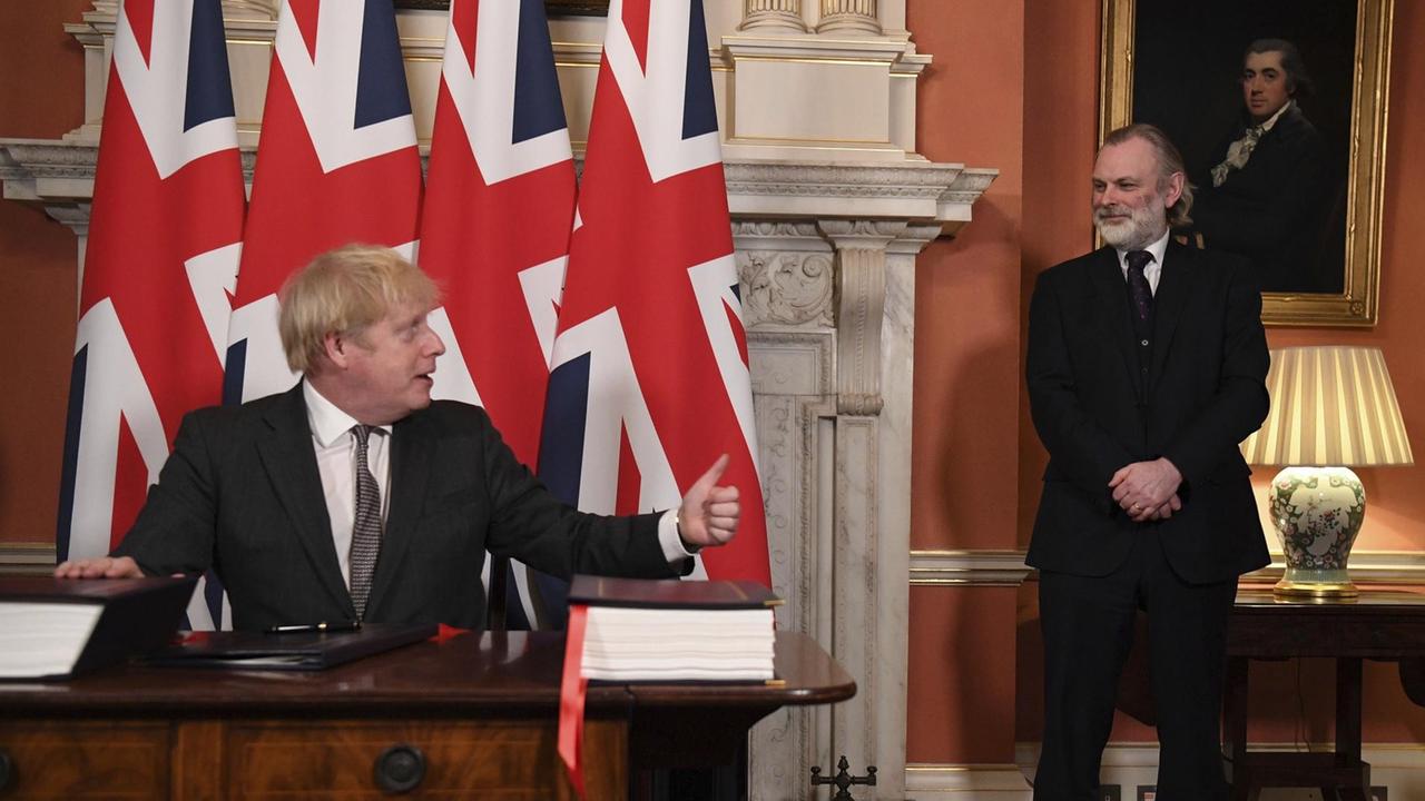 Der britische Botschafter bei der EU Tim Barrow, rechts, schaut zu, nachdem Premierminister Boris Johnson das Handels- und Kooperationsabkommen zwischen der EU und Großbritannien unterzeichnet. Der britische Botschafter bei der EU Tim Barrow, rechts, schaut zu, nachdem Premierminister Boris Johnson das Handels- und Kooperationsabkommen zwischen der EU und Großbritannien unterzeichnet.
