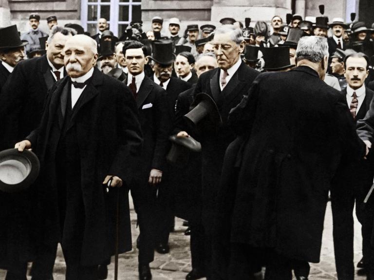 Unterzeichnung des Versailler Friedensvertrages am 28. Juni 1919. Georges Clemenceau und Woodrow Wilson verlassen mit anderen Männern das Schloß von Versailles nach der Vertragsunterzeichnung.