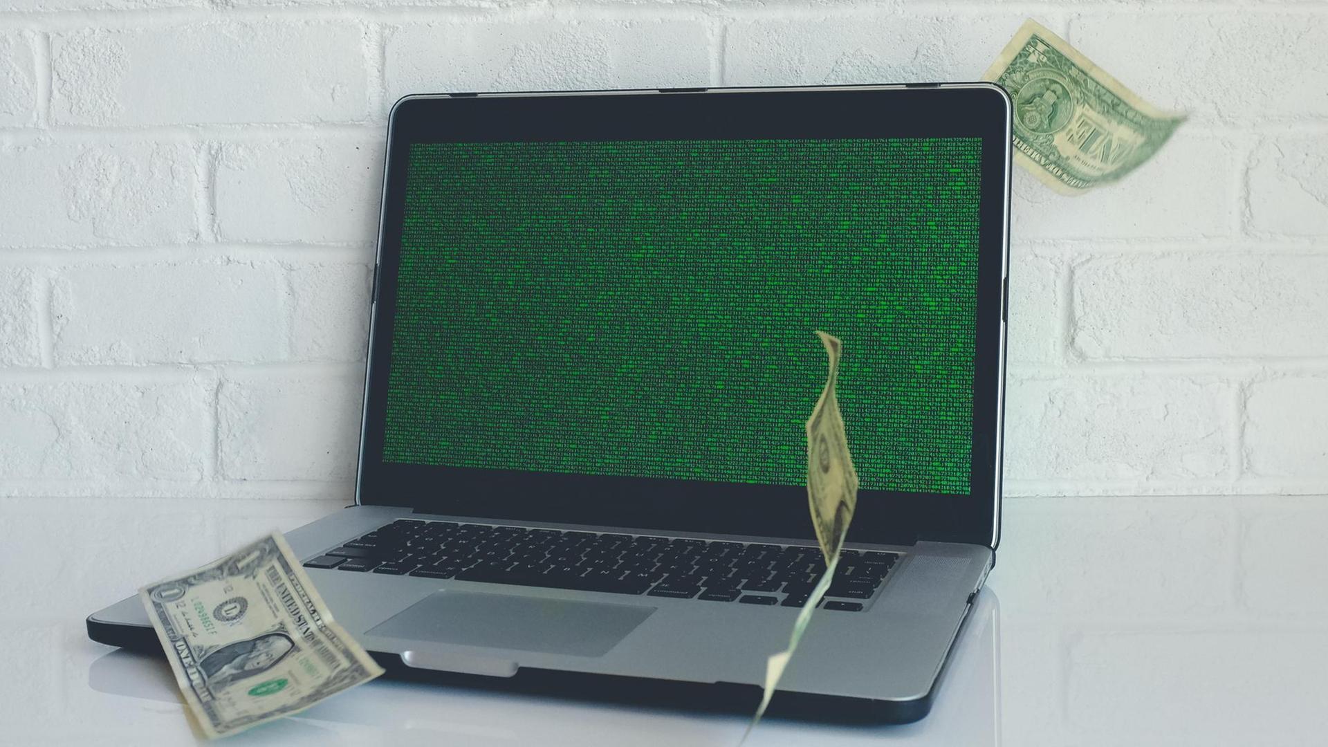 Geldscheine fliegen um einen Laptop herum Geldscheine fliegen um einen Laptop herum