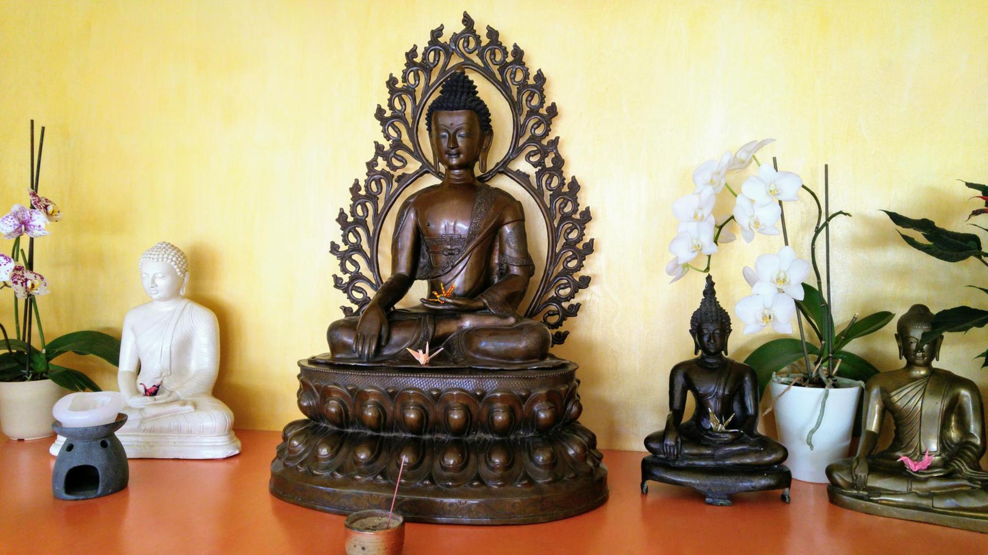 Figuren des historischen Buddha im Meditationsraum der Buddhistischen Gesellschaft Hamburg.