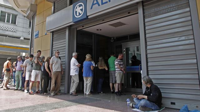 Eine Schlange von Menschen vor einer Bank in Athen.