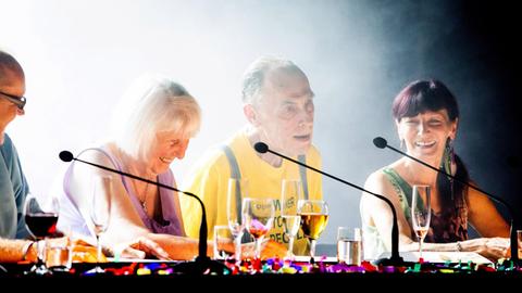 Szene aus in „All the Sex I´ve ever had“: Vier ältere Frauen und Männer sitzen an einem Tisch auf der Bühne und sprechen in Mikrofone.
