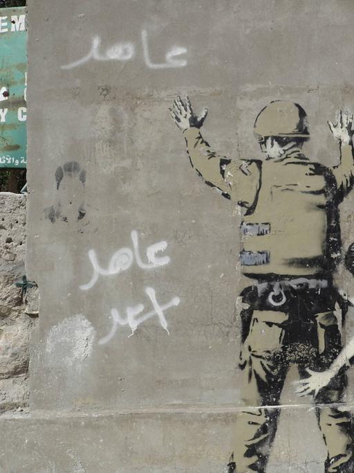 Sperrmauer mit Graffito von Banksy auf der palästinensischen Seite, zwischen Bethlehem, Westjordanland und Jerusalem.