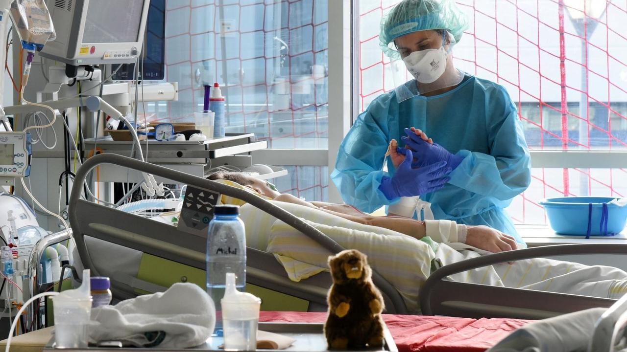 Auf der Covid-Station, einem Bereich der Operativen Intensivstation des Universitätsklinikums Leipzig, steht eine Physiotherapeutin am Bett einer Patientin. Auf der Covid-Station, einem Bereich der Operativen Intensivstation des Universitätsklinikums Leipzig, steht eine Physiotherapeutin am Bett einer Patientin.