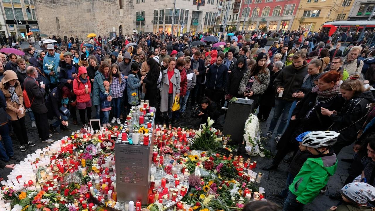 Halles Einwohner und Gäste der Stadt trauern seit dem Anschlag auf die Synagoge öffentlich auf dem Marktplatz, zünden tausende Kerzen an und legen Blumen nieder