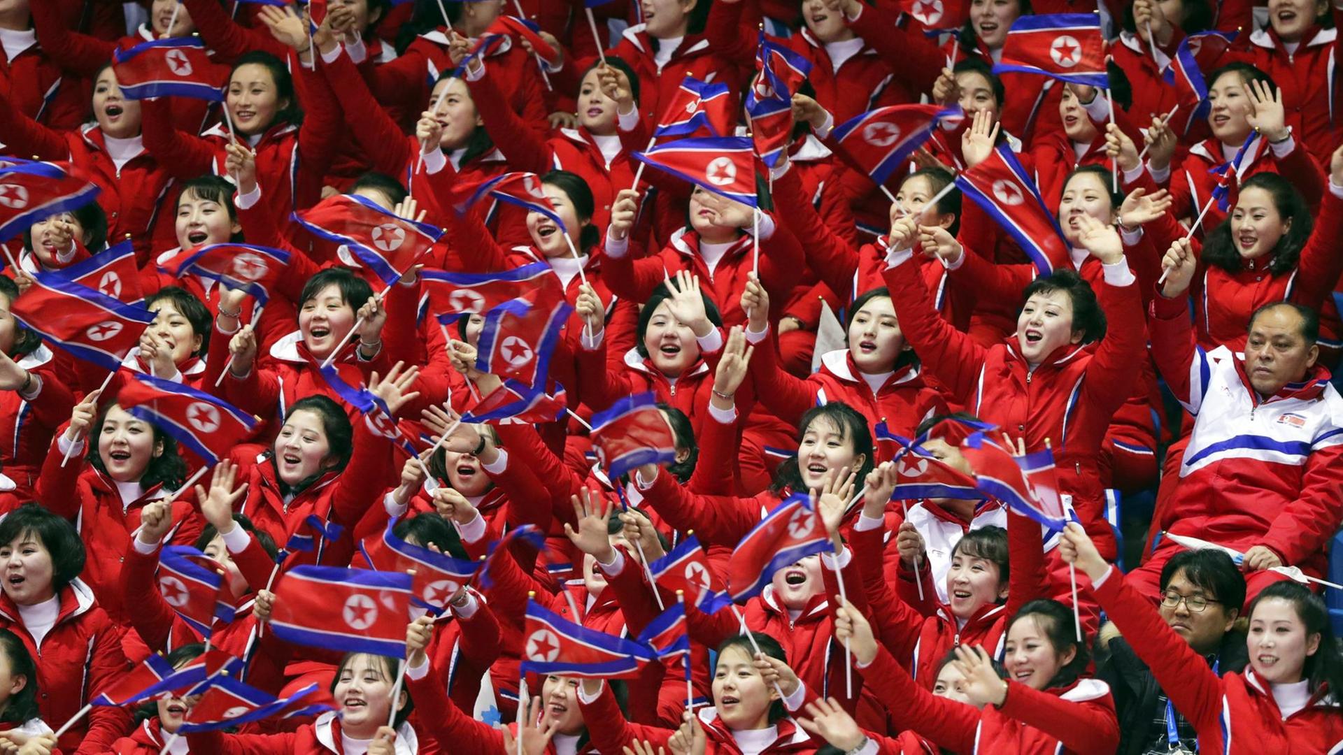 Ein Block nordkoreanischer Fans feuert die Eisschnellläufer an Ein Block nordkoreanischer Fans feuert die Eisschnellläufer an