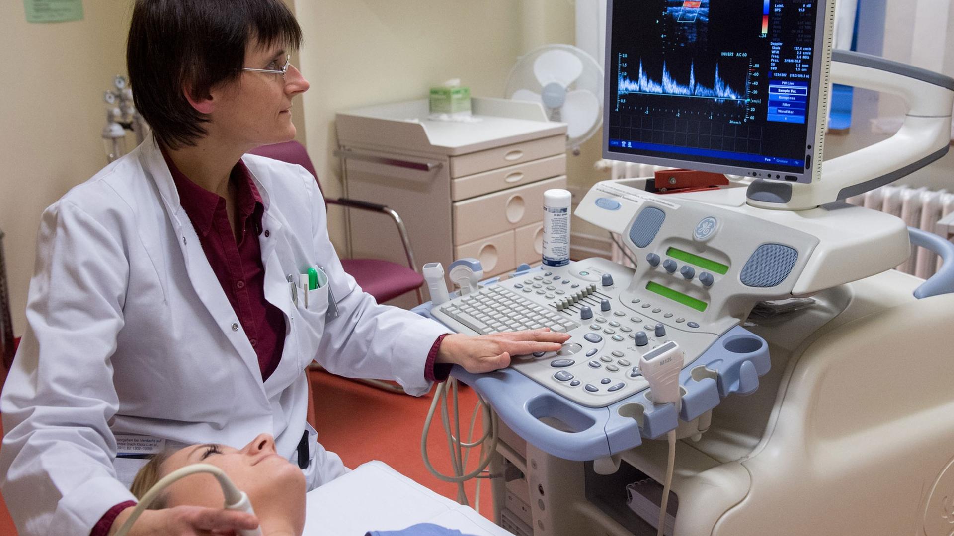 Ultraschall-Untersuchung der Schilddrüse im Krankenhaus, Ärztin mit Patientin. Ultraschall-Untersuchung der Schilddrüse im Krankenhaus, Ärztin mit Patientin.