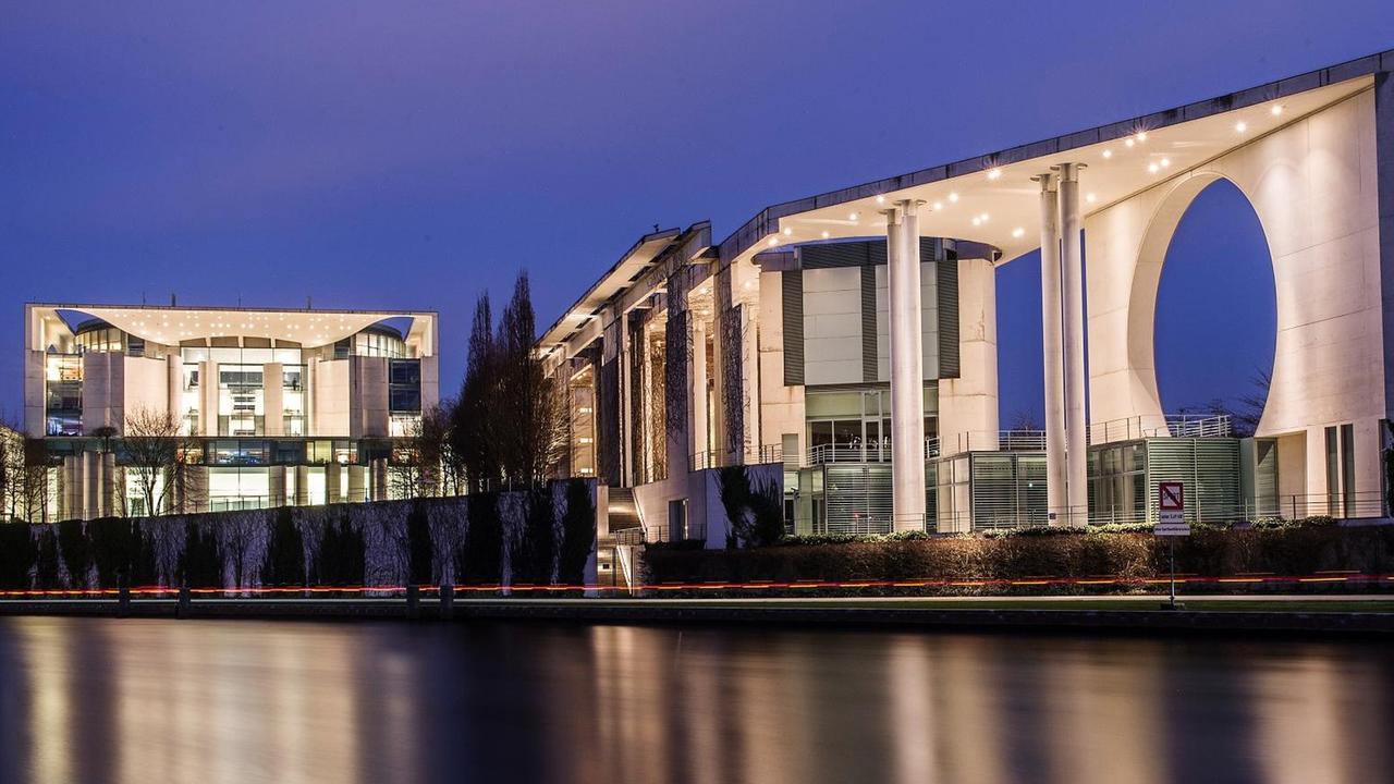 Das Bundeskanzleramt wird in der blauen Stunde der Abenddämmerung in Berlin beleuchtet und spiegelt sich in der Spree. Das Bundeskanzleramt wird in der blauen Stunde der Abenddämmerung in Berlin beleuchtet und spiegelt sich in der Spree.