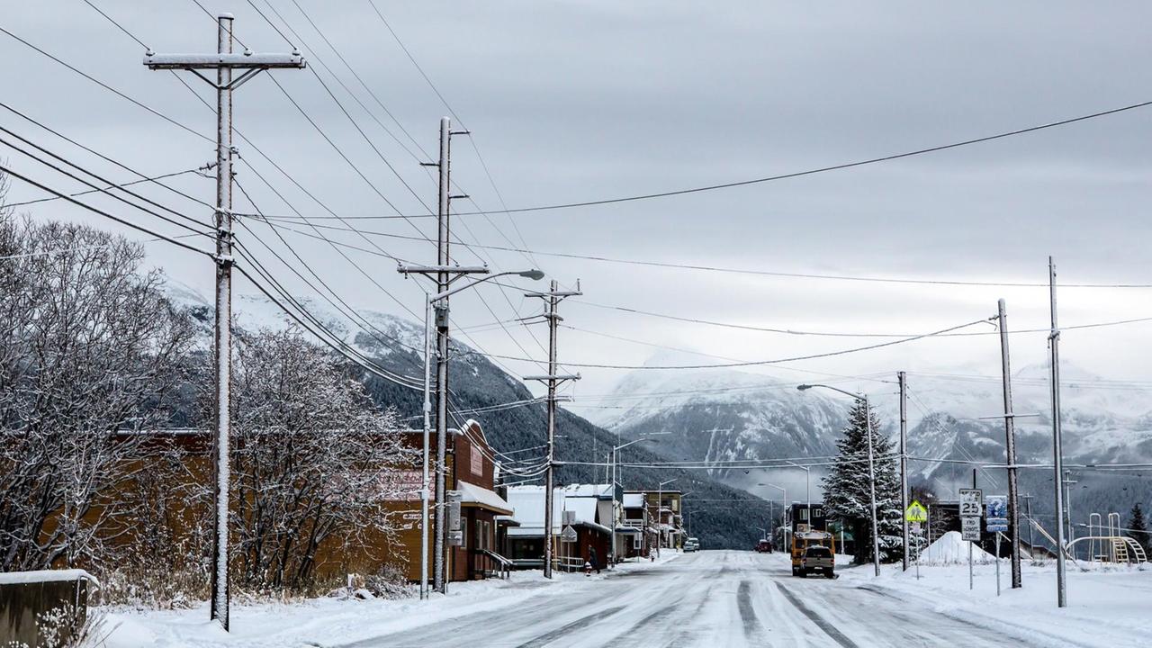 Strommasten stehen entlang einer leeren Straße in Haines, Alaska.