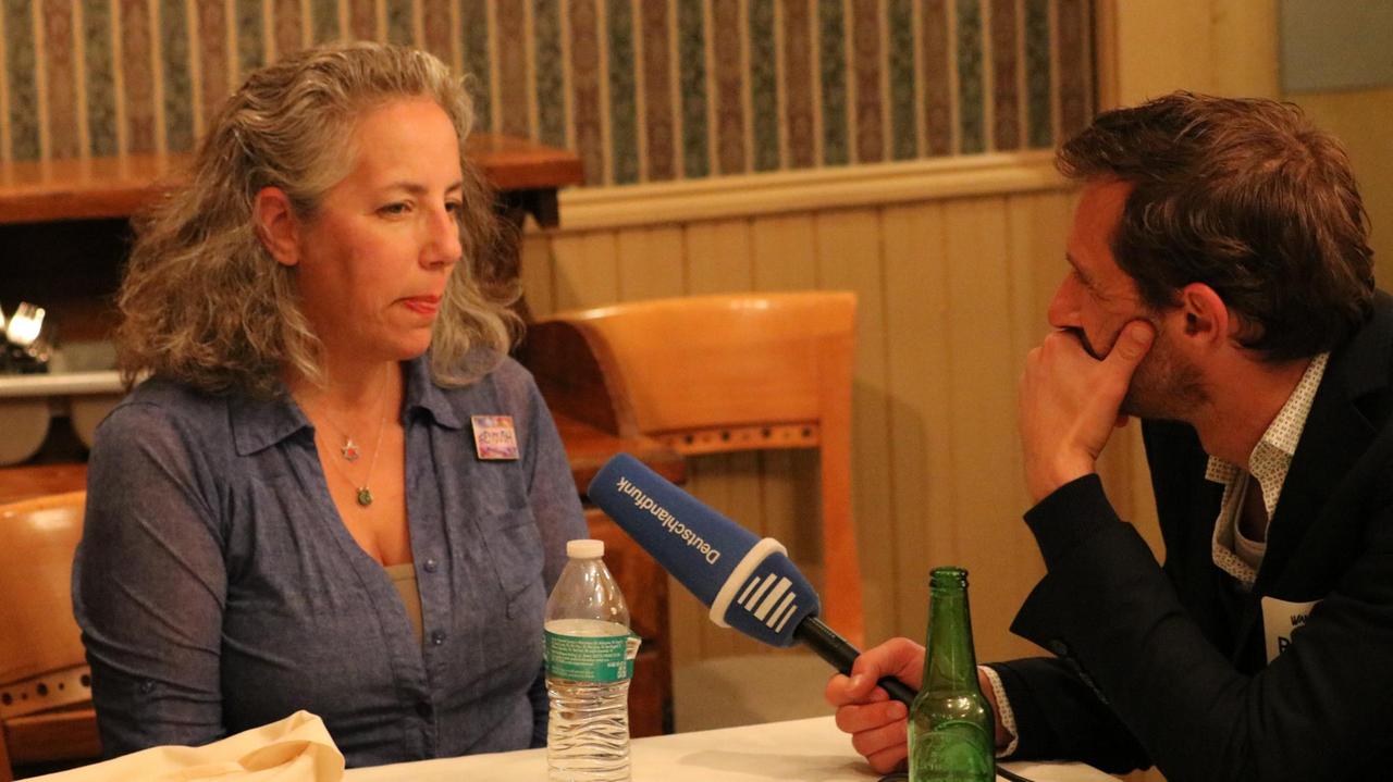 Lisa Beth Weber unterstützt den demokratischen Kandidaten Scott Wallace. Sie ist im Interview mit Jasper Barenberg und spricht ins Mikrofon. Lisa Beth Weber unterstützt den demokratischen Kandidaten Scott Wallace. Sie ist im Interview mit Jasper Barenberg und spricht ins Mikrofon.