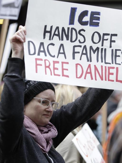 Eine Demonstrantin hält ein Schild in der Hand mit der Aufschrift: "ICE - Hands off Daca-families, free Daniel"
