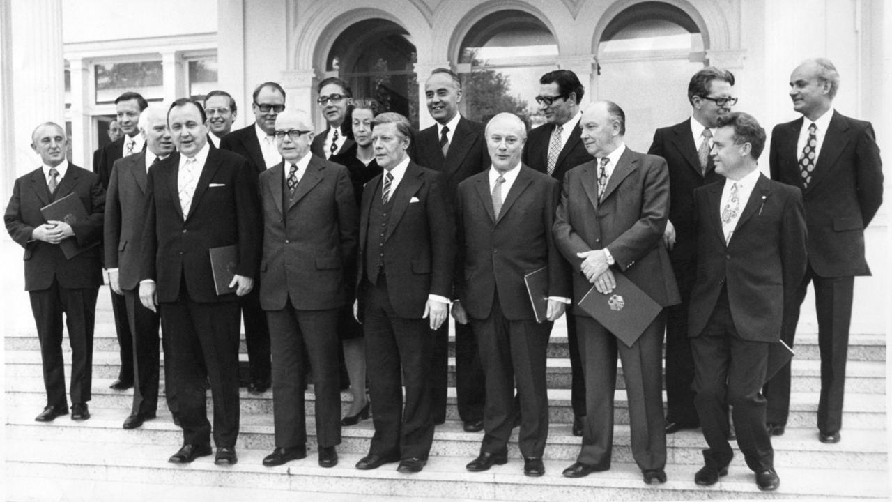 Bundespräsident Gustav Heinemann mit den Mitgliedern des Kabinetts Schmidt nach Überreichung der Ernennungsurkunden am 16.05.1974, hier vor der Villa Hammerschmidt. Von links: Helmut Rohde, SPD (Wissenschaft), Karl Ravens, SPD (Städtebau), Walter Arendt, SPD (Arbeit), Hans-Dietrich Genscher, FDP (Auswärtiges), Kurt Gscheidle, SPD (Verkehr und Post), Josef Ertl, FDP (Landwirtschaft), Bundespräsident Gustav Heinemann, Erhard Eppler, SPD (Entwicklungshilfe), Katharina Focke, SPD (Familien), Bundeskanzler Helmut Schmidt, SPD, Hans Friederichs, FDP, (Wirtschaft), Georg Leber, SPD (Verteidigung), Werner Maihofer, FDP (Innen), Egon Franke, SPD (Innerdeutsche Beziehungen), Hans-Jochen Vogel, SPD (Justiz), Hans Apel, SPD (Finanz) und Hans Matthöfer, SPD (Forschung). Bundespräsident Gustav Heinemann mit den Mitgliedern des Kabinetts Schmidt nach Überreichung der Ernennungsurkunden am 16.05.1974, hier vor der Villa Hammerschmidt. Von links: Helmut Rohde, SPD (Wissenschaft), Karl Ravens, SPD (Städtebau), Walter Arendt, SPD (Arbeit), Hans-Dietrich Genscher, FDP (Auswärtiges), Kurt Gscheidle, SPD (Verkehr und Post), Josef Ertl, FDP (Landwirtschaft), Bundespräsident Gustav Heinemann, Erhard Eppler, SPD (Entwicklungshilfe), Katharina Focke, SPD (Familien), Bundeskanzler Helmut Schmidt, SPD, Hans Friederichs, FDP, (Wirtschaft), Georg Leber, SPD (Verteidigung), Werner Maihofer, FDP (Innen), Egon Franke, SPD (Innerdeutsche Beziehungen), Hans-Jochen Vogel, SPD (Justiz), Hans Apel, SPD (Finanz) und Hans Matthöfer, SPD (Forschung).
