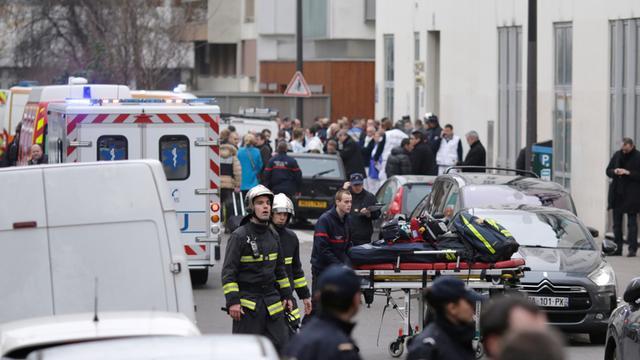 Feuerwehrleute und Polizisten vor der Redaktion der französischen Satirezeitschrift "Charlie Hebdo"