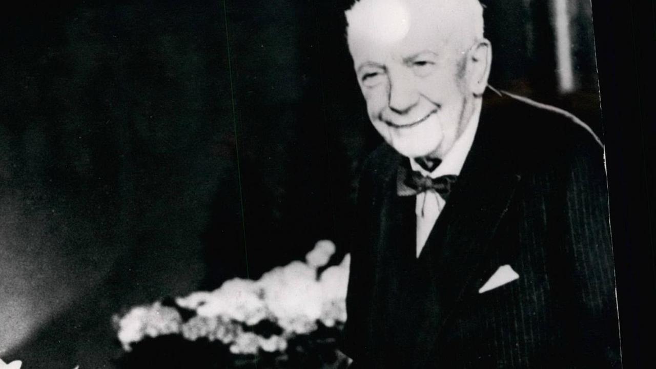 Ein alter Mann zeigt große Freude über einen Blumenstrauss auf einer schwarz-weiß-Fotographie. Ein alter Mann zeigt große Freude über einen Blumenstrauss auf einer schwarz-weiß-Fotographie.