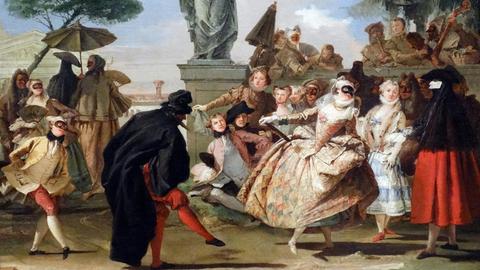 Figuren der Commedia dell arte haben sich in ihren typischen Kostümen und mit ihren Masken zu einem Tanz zusammen gefunden.