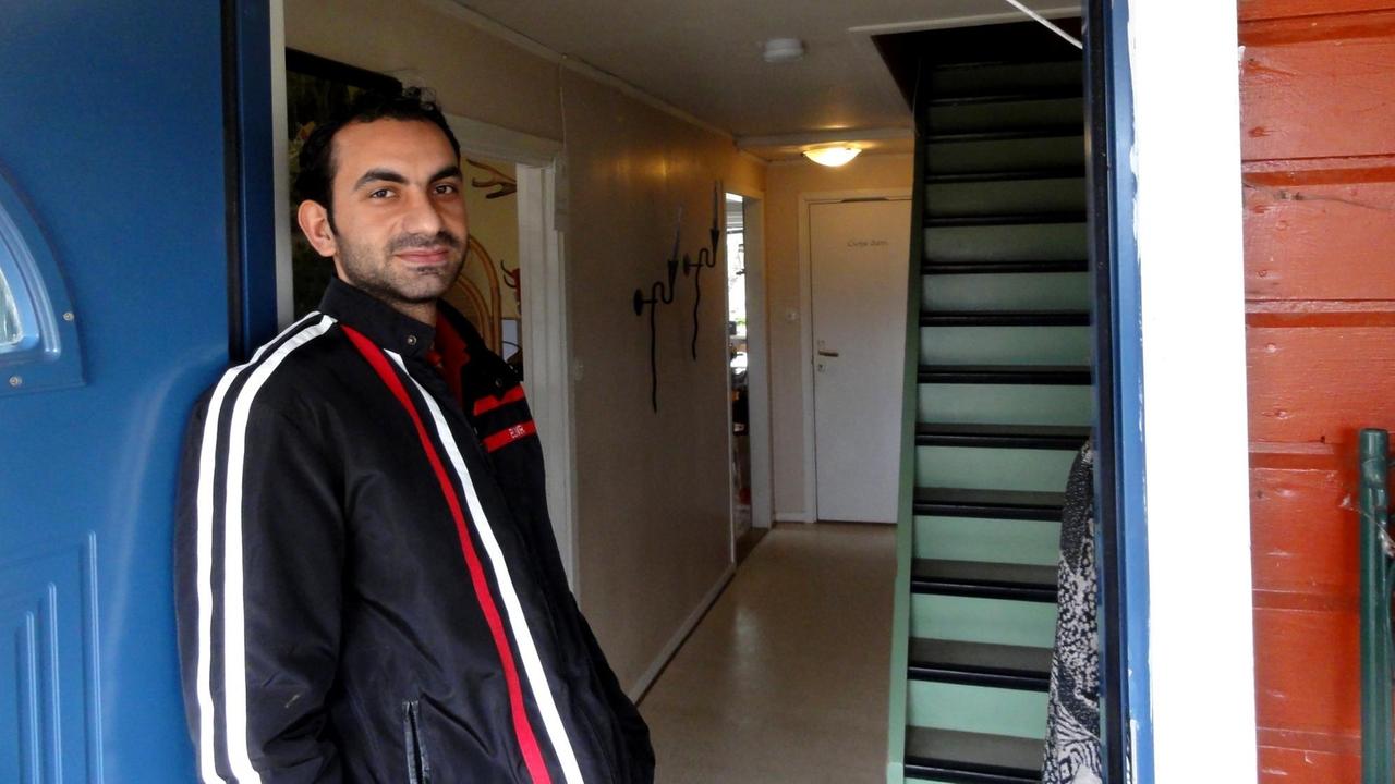 Der Syrer Mustafa aus Aleppo steht in der Tür eines roten Holzhauses nahe Urshult im südschwedischen Småland Der Syrer Mustafa aus Aleppo steht in der Tür eines roten Holzhauses nahe Urshult im südschwedischen Småland