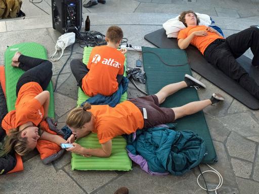 Attac-Aktivisten machen es sich auf ihren Schlafsäcken in der Paulskirche gemütlich. Zuvor hatten sie als symbolischer Protest den Gedenkort besetzt und wollen dort über Nacht bleiben.