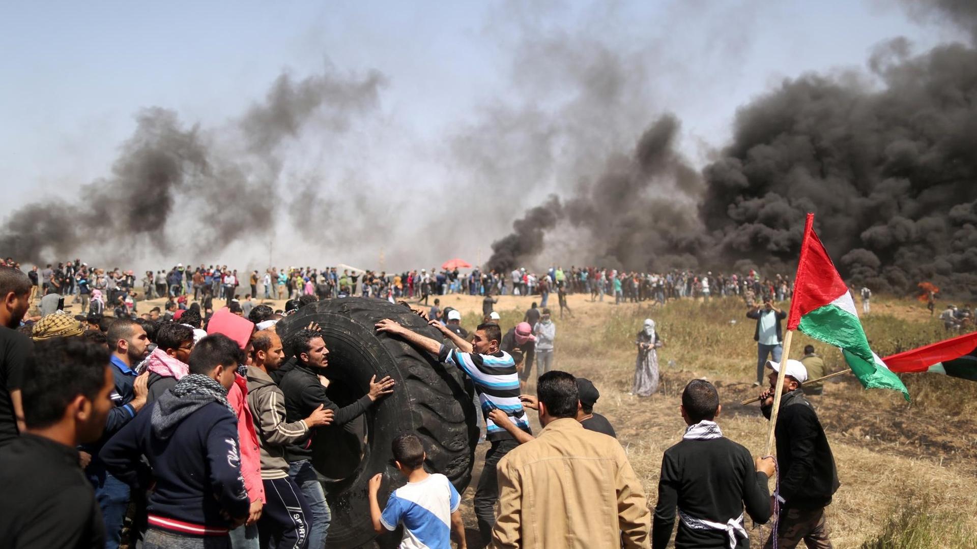 Bei Protesten im Gaza-Streifen setzen Palästinenser Autoreifen in Brand. Bei Protesten im Gaza-Streifen setzen Palästinenser Autoreifen in Brand.