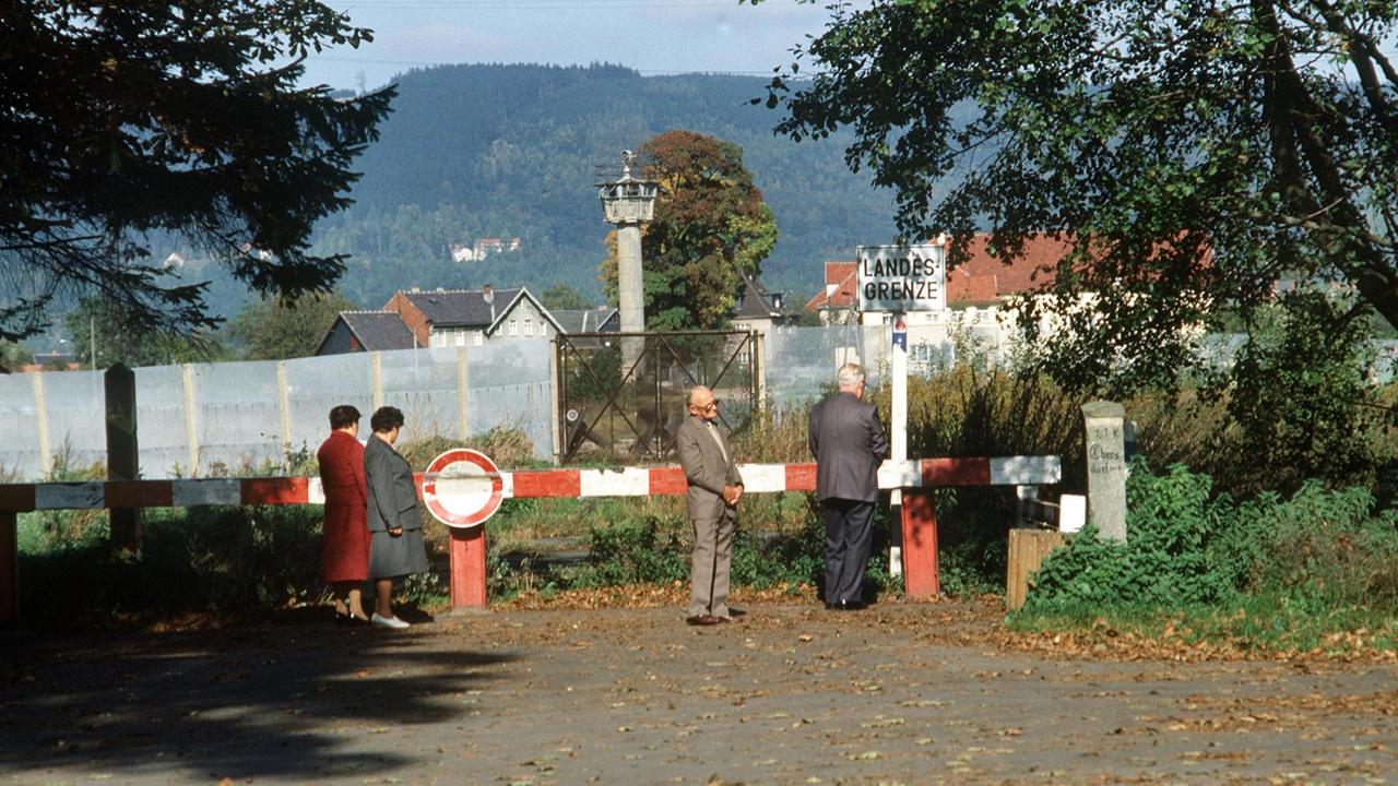 Ein Schlagbaum an der innerdeutschen Grenze bei Sonneberg in der DDR, im Hintergrund der Grenzzaun und ein Wachturm, aufgenommen 1986.