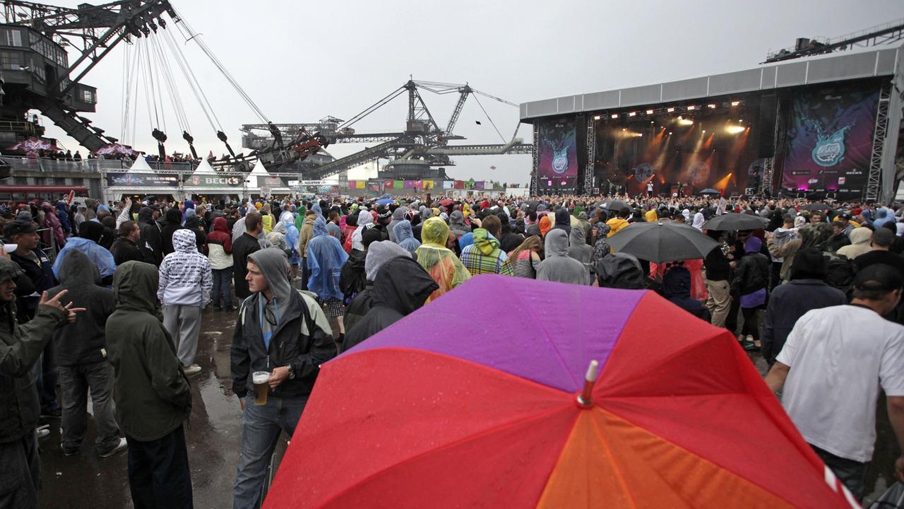 Besucher des HipHop- und Reggae-Festivals "Splash!" stehen am Samstag (11.07.2009) im Regen in der Baggersstadt Ferropolis. Besucher des HipHop- und Reggae-Festivals "Splash!" stehen am Samstag (11.07.2009) im Regen in der Baggersstadt Ferropolis.